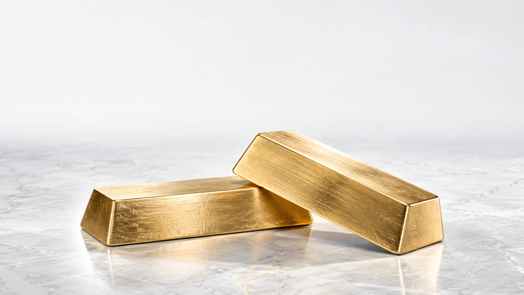 Illustrative brushed gold ingots on pale stone
